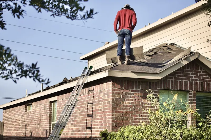 Professional roofer working on a residential roof in Siesta Village